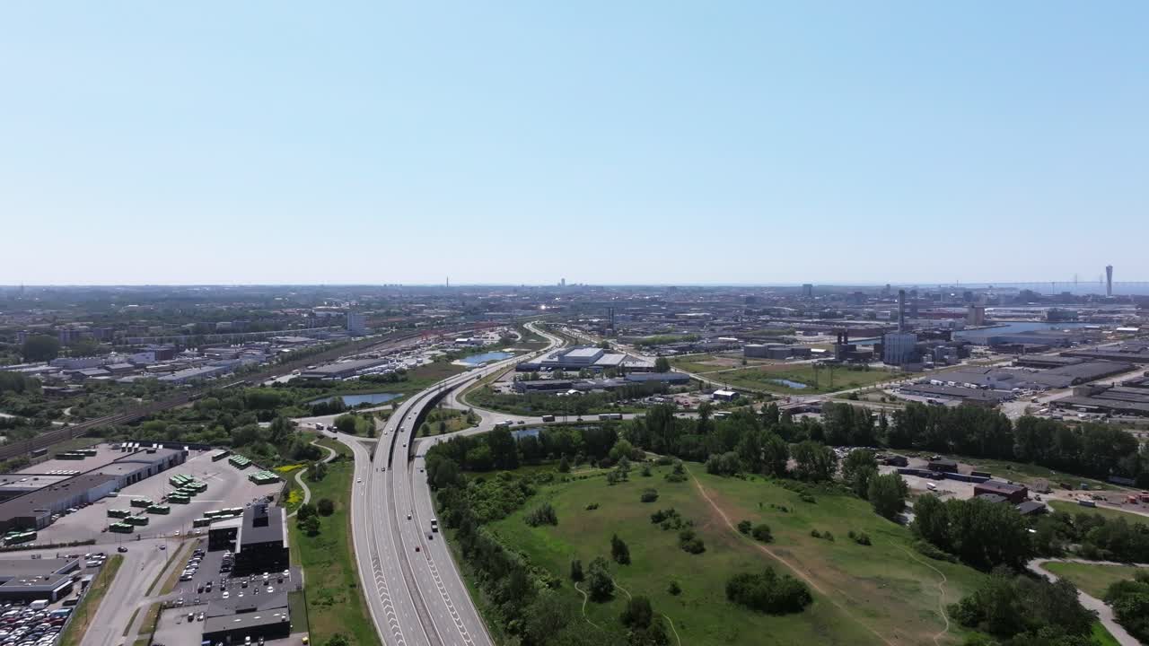 Aerial forward over freeway leading to Malm&ouml;, Sweden on a sunny summer day