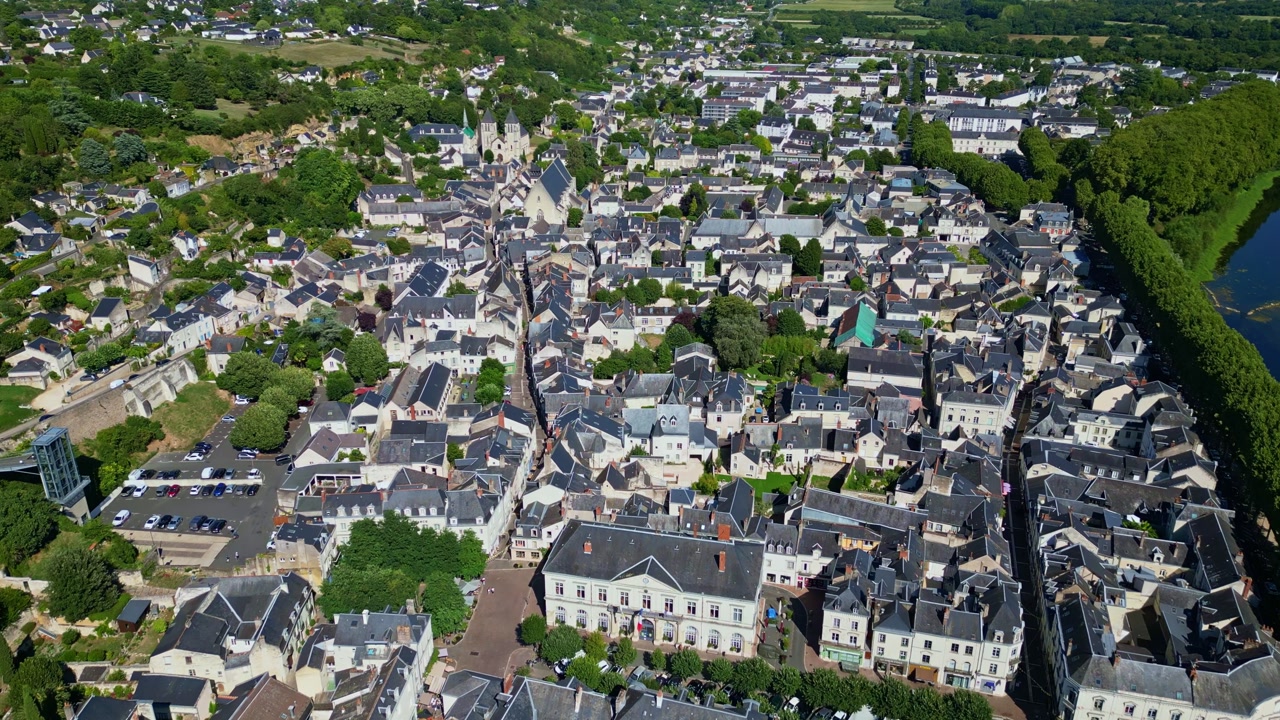 Aerial drone shot moving forward above Chinon, showing Saint-Mexme Collegiate and the Vienne River on the side.