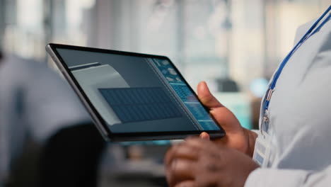 close up of rd office employee uses touchscreen device, creating eco solar gadget