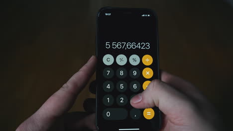 person using a smartphone calculator app