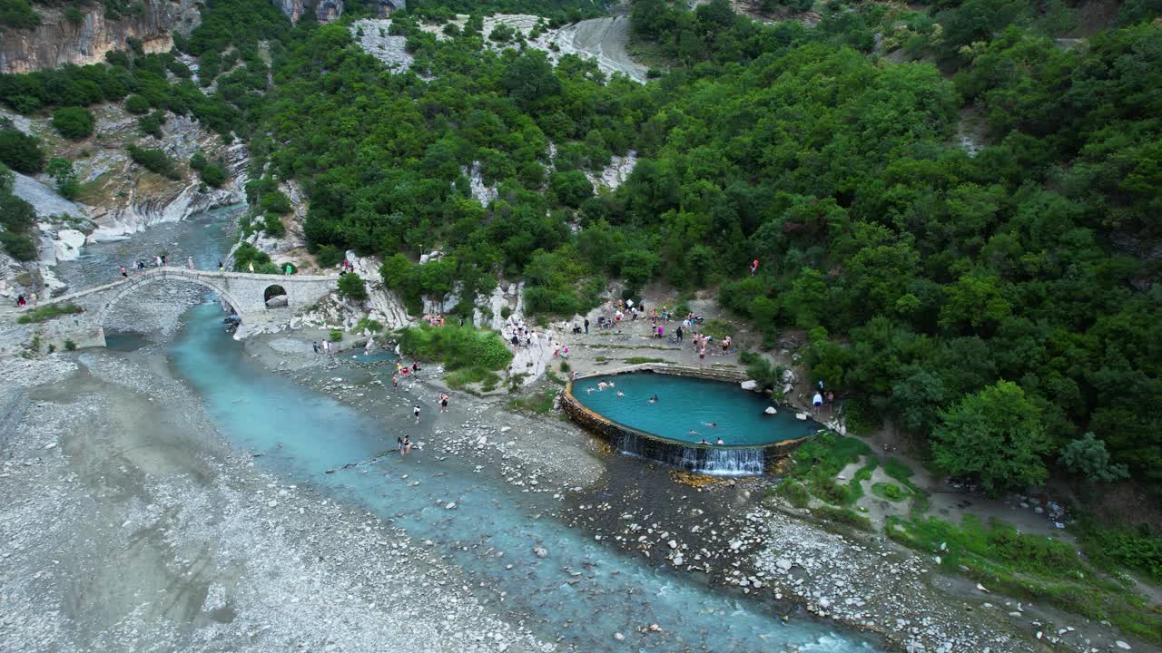 Benje thermal water natural pond pool tourists enjoy warm spring near ancient stone river bridge