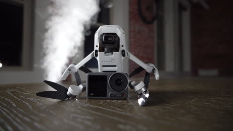 dji mini 2 drone holding osmo action camera in dramatic fumes