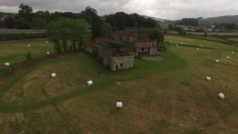 An-aerial-view-of-a-large-industrial-brown-field-with-many-hay-bales-in-4K