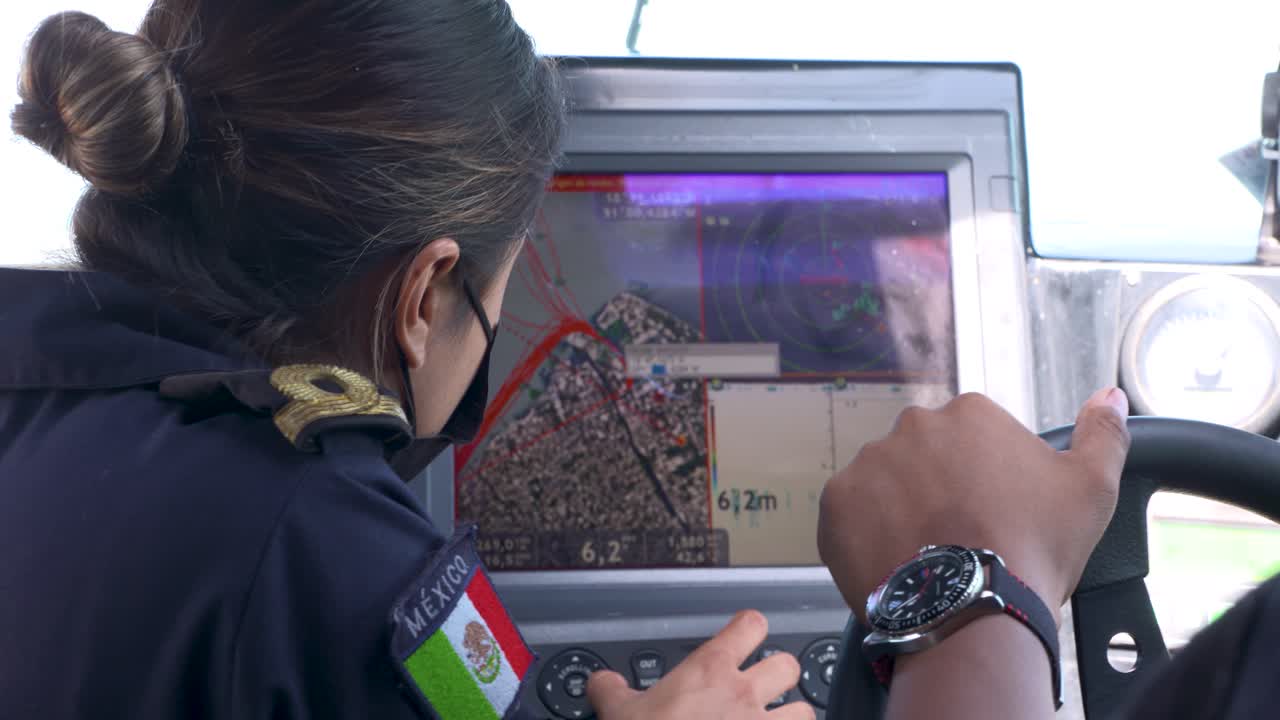 Mexican marines sailing and driving at the bridge of a a patrol boat