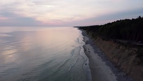 Aerial-view-of-the-sunset-over-the-Baltic-Sea-near-The-Dutchman's-Cap,-Lithuania