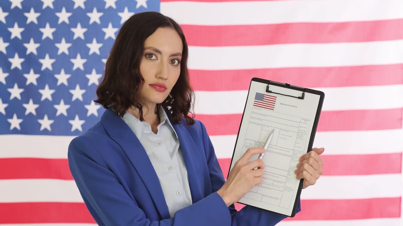 Woman holding a USA visa application form in front of an American flag