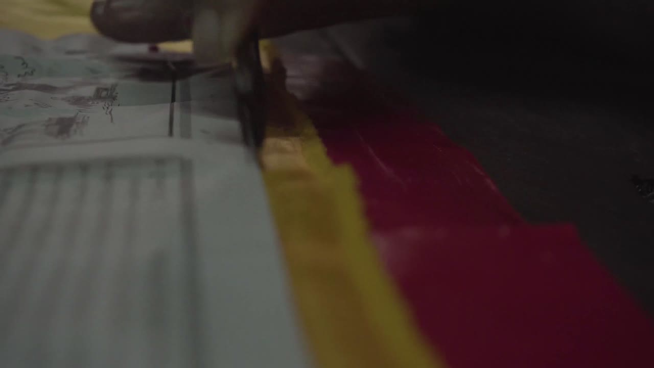 Old lady tailor use marking for cut a yellow fabric