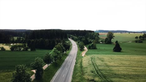 Enjoy-drone-footage-of-a-charming-country-road-winding-through-Bavaria,-Germany