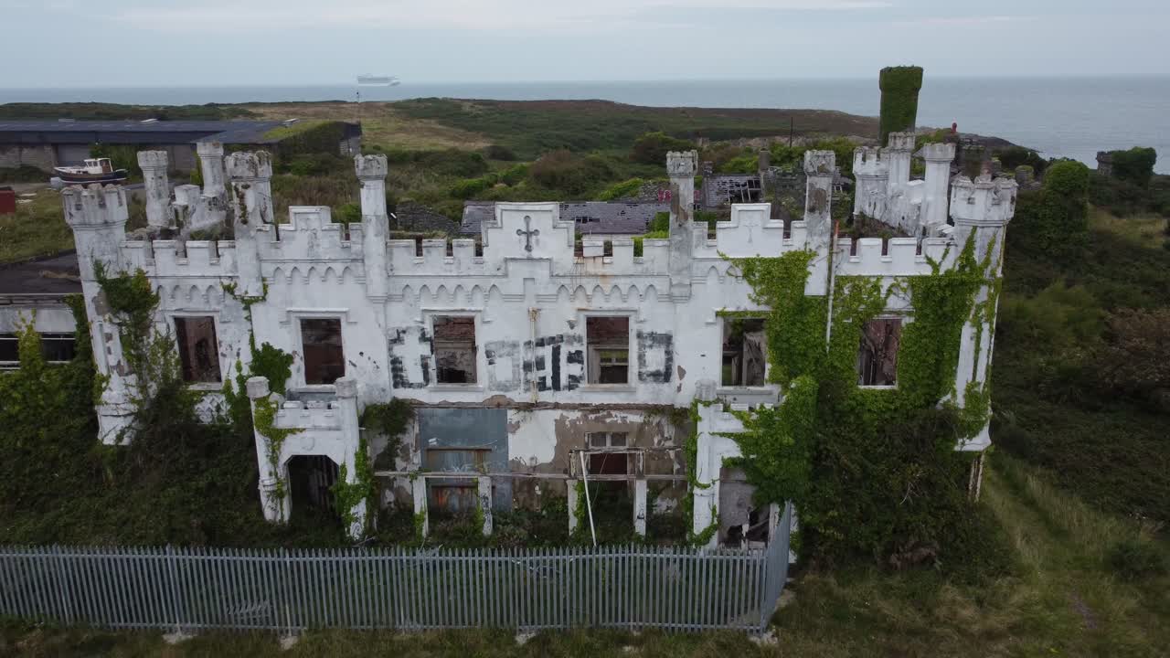 Soldiers point house aerial view graffiti covered castle hotel mansion on Holyhead breakwater