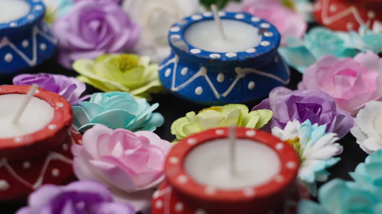 Scented candles among flowers for Diwali festival holiday