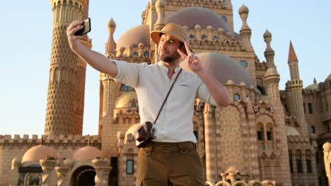 man takes a selfie on the phone in the old town market in cairo mosque.
