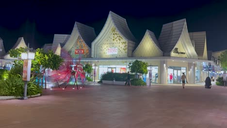 illuminated mall facade with people walking