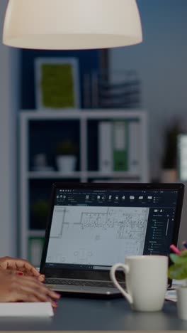 vertical video african architect analysing digital plans from laptop