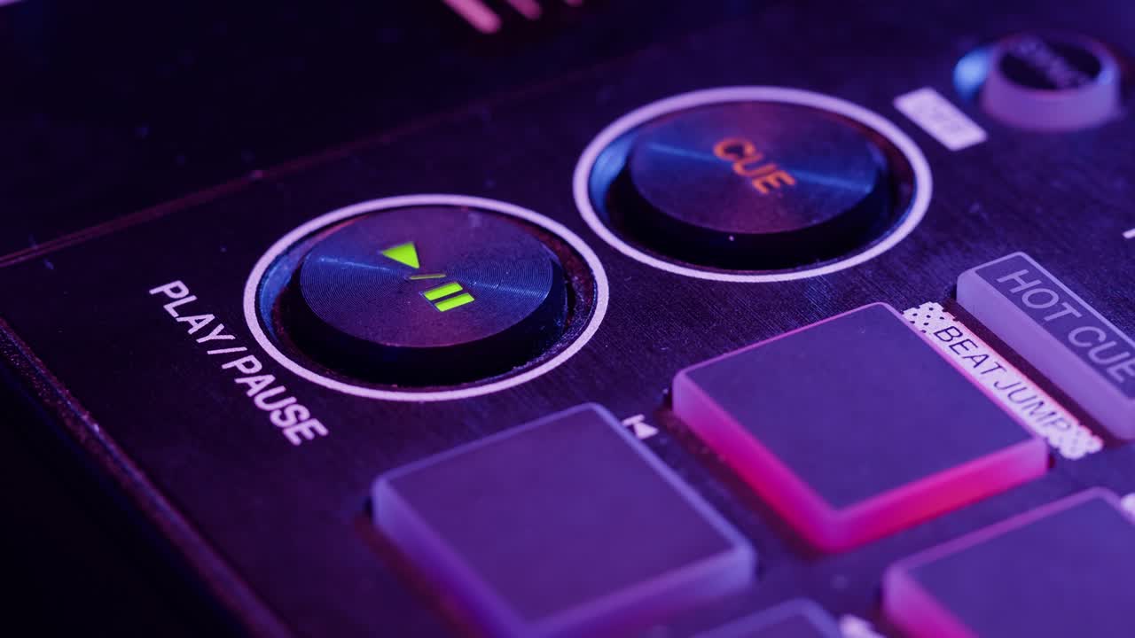 DJ with headphones and sunglasses playing music on festival in night club. Techno musician performing at nightclub for concert crowd of people, city bar.