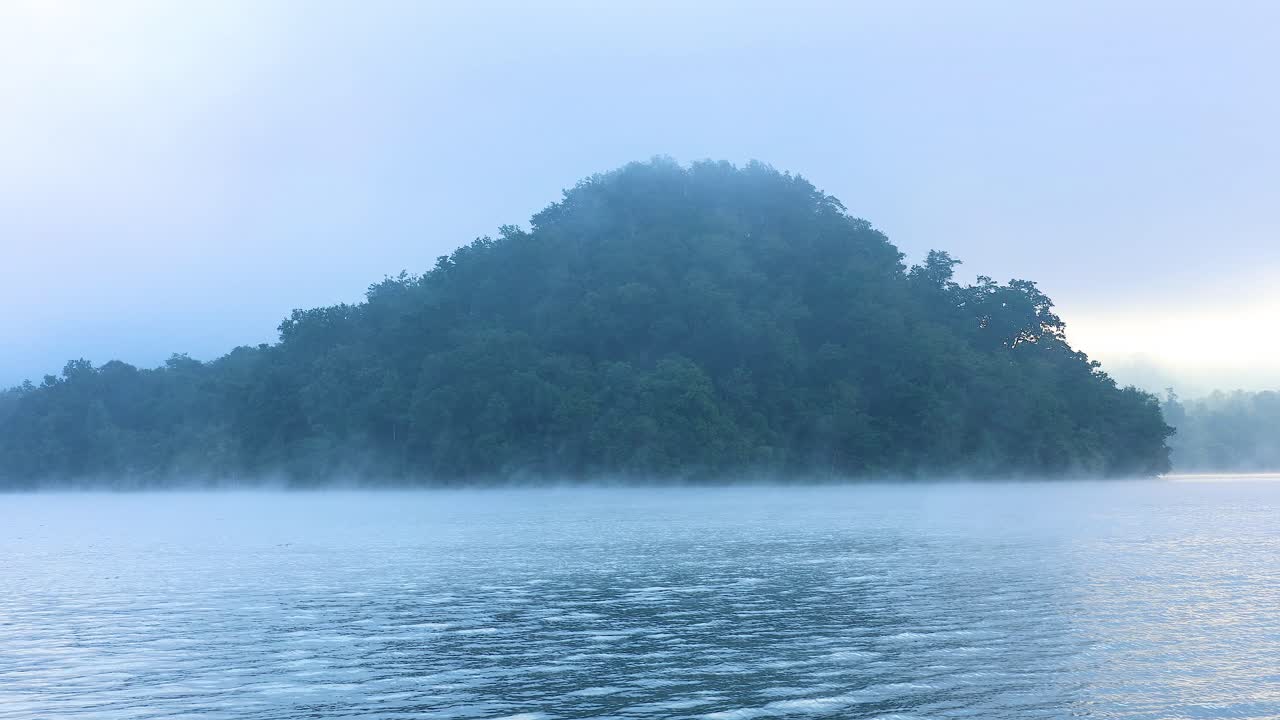 먼 산과 배와 함께 안개가 가득한 강 풍경