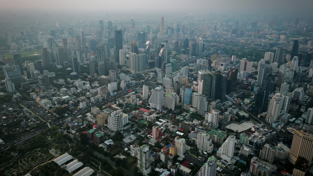 Aerial Scenic Drone Footage of the Skyline of Downtown Bangkok, Thailand Covered in Smog during Sunset during the Smokey Burning Season