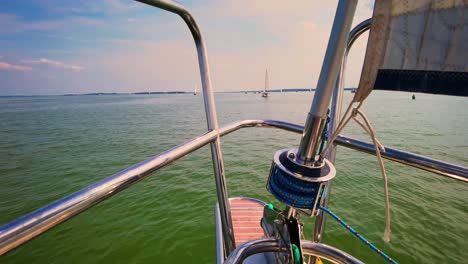 The-front-bow-of-a-white-sailing-boat-with-blue-sky-and-sea-background