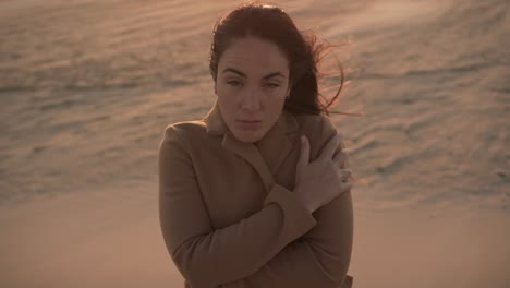 Tender-woman-on-seashore-on-windy-day