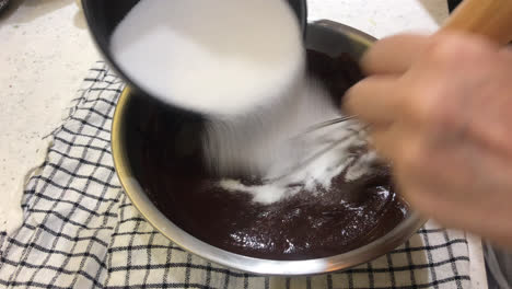 stir-powder-with-chocolate-and-sugar-for-making-brownie