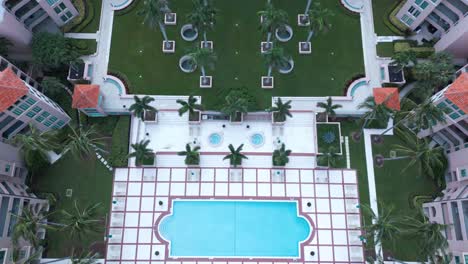 aerial view of modern upscale condo complex, pool and dock in boca raton, florida usa, real estate concept, drone shot
