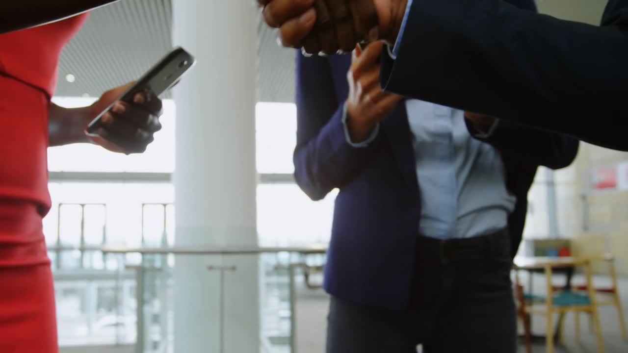 Business people shaking hands in office 4k