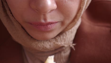 close-up of a woman eating bread