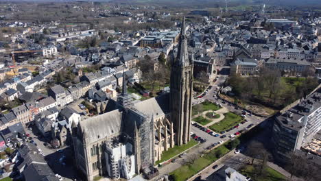 aerial view of a city with a cathedral under renovation