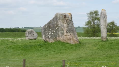 raven flying above avebury stone circle, neolithic monument england