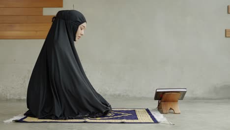 side view video of young muslim women are performing prayers. islamic religion,part 1