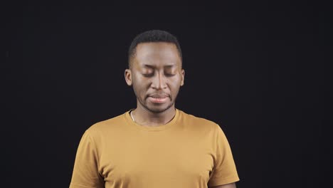 young african man with low motivation. unhappy and angry eyes.