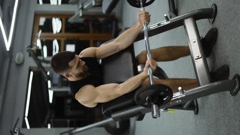 handsome bodybuilder doing weight lifting in gym