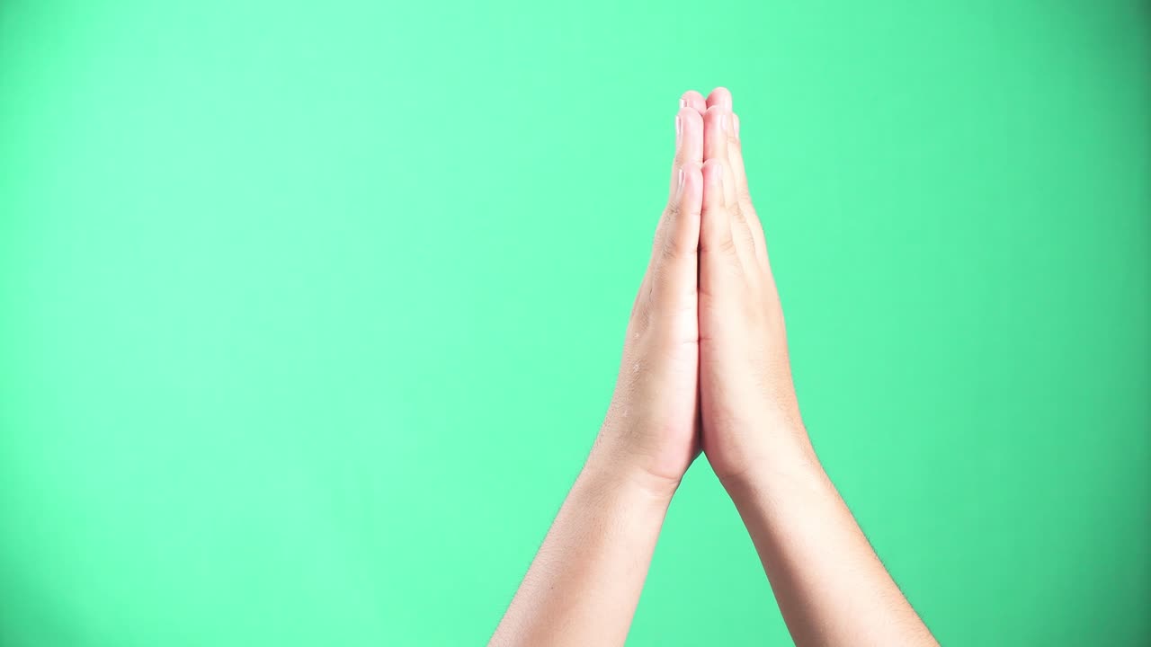 A person putting their palms together in prayer. 4k green screen