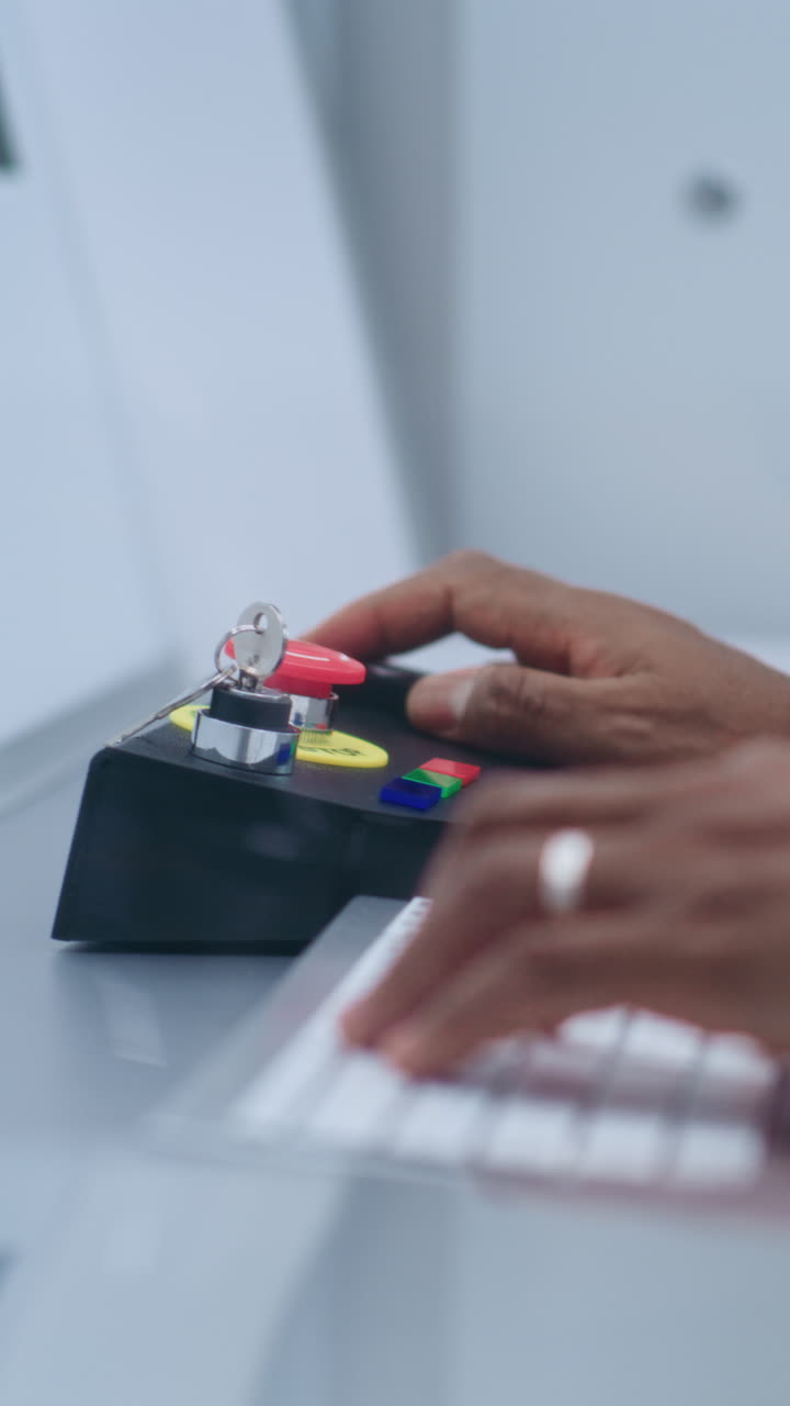 Person Operating a Computer and Control Panel
