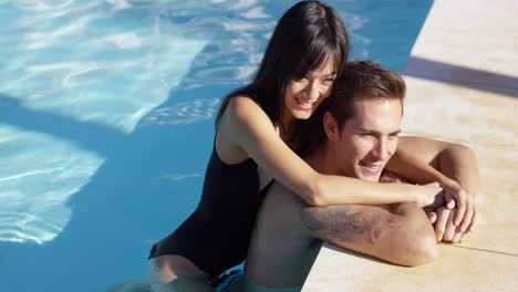 Woman-in-black-swim-suit-hugs-her-boyfriend