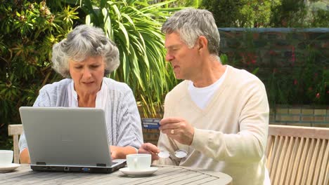 mature couple buying online using a credit card