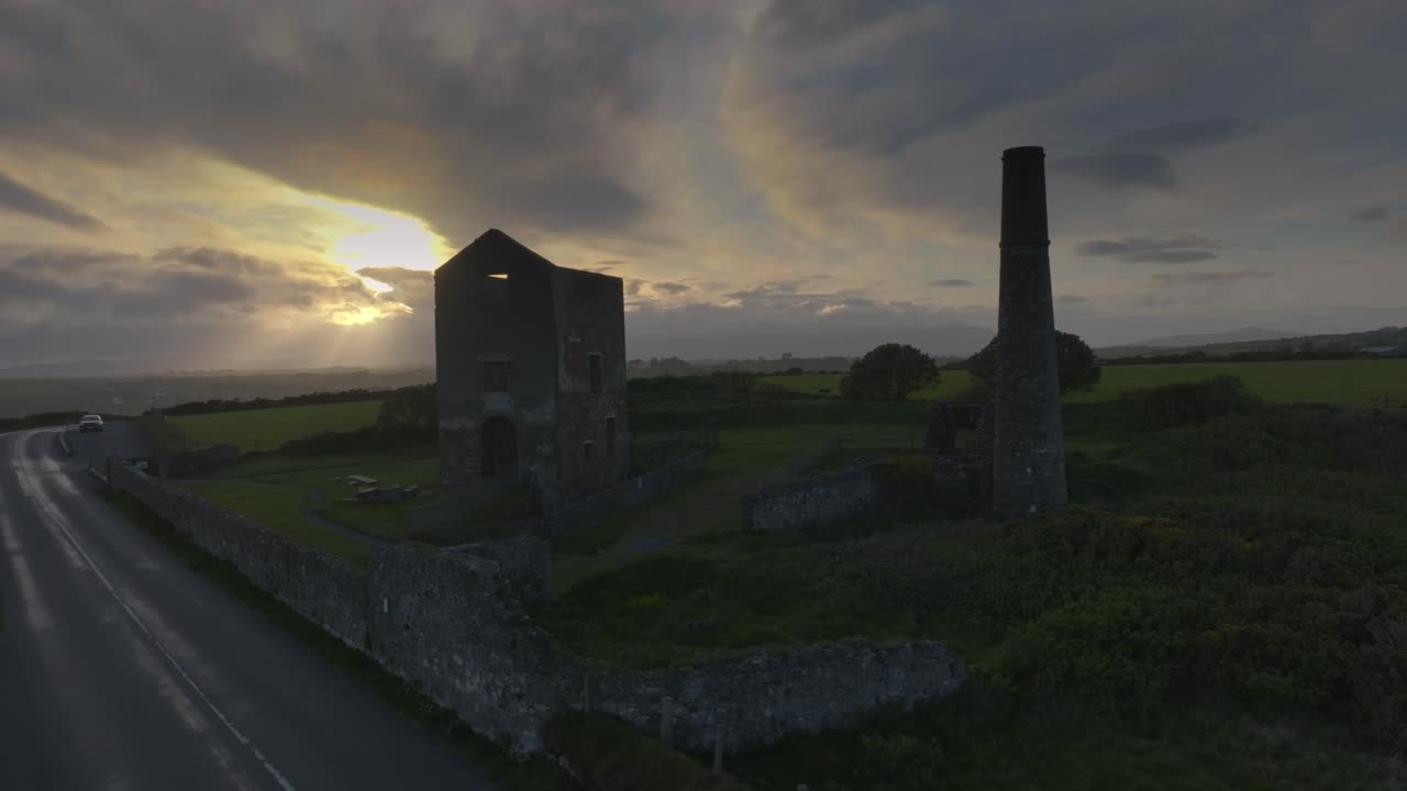 Tankardstown Copper Mine, County Waterford, Ireland, April 2025. Drone orbits counterclockwise, historic ruins at golden hour, moody sky and rural landscape