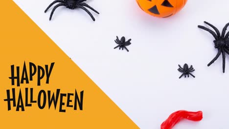 Animation-of-happy-halloween-text-over-spiders