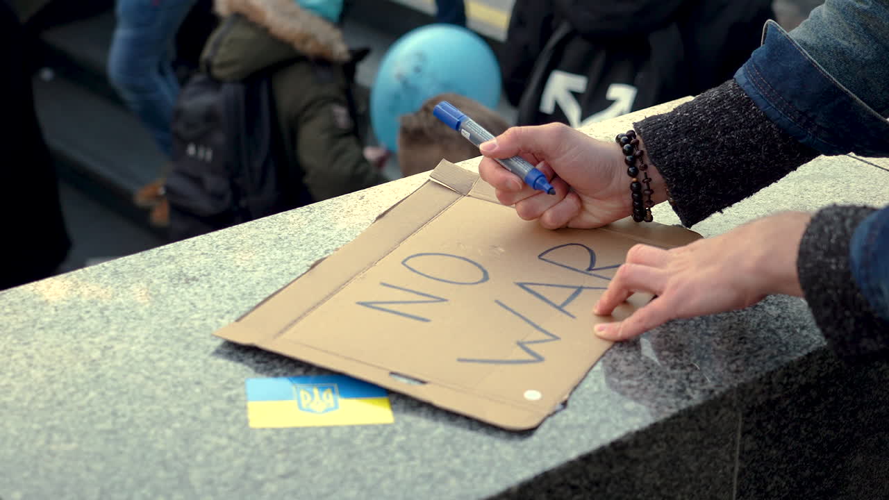Preparing a protest sign for a demonstration against war in Ukraine