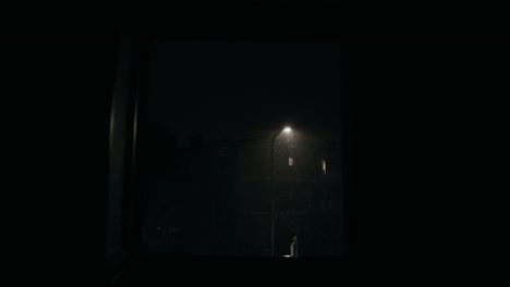 view through apartment window of thunderstorm at night in bassano del grappa, italy. dolly-in shot