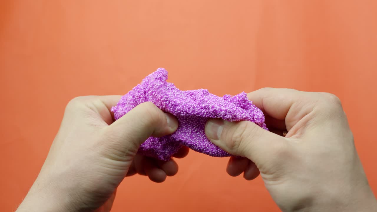 Destress therapy, floam with glitter in person hands, POV