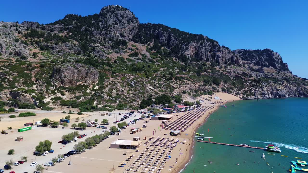 Tsambika beach in Faliraki, Rhodes in Greece filmed with the drone from above with Mediterranean Sea in the summer holiday