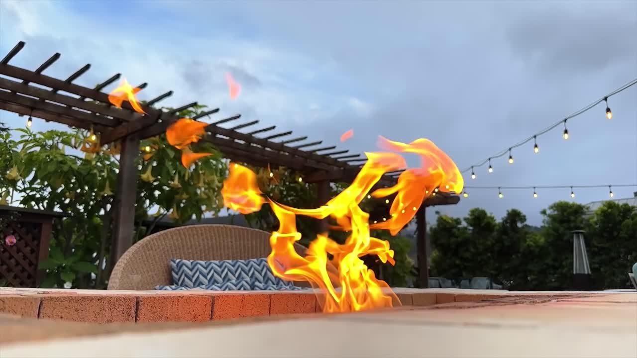 Yellow Orange Flames From Garden Fire Pit In Backyard or resort Close Up, Low Angle Shot