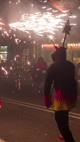 barcelona, spain - 22 september 2023 : crowds in the street for the fire run or correfoc, during la merce festival, barcelona spain in vertical