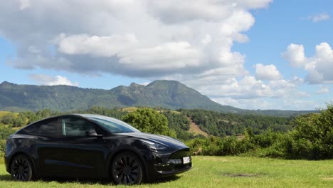 black car driving through picturesque mountainous area