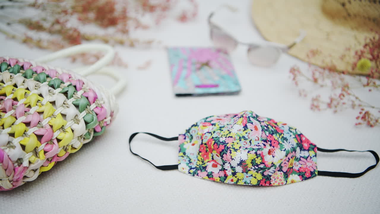 Post coronavirus travel flat lay concept, mandatory face mask when going on a trip, colorful