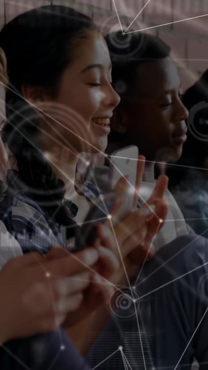 Vertical video: Students tapping phones on bench, camera panning while HUD nodes showing tech sync