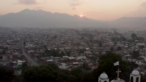 aerial passing by guadalupe church during sunset, san cristobal de las casas, chiapas, mexico