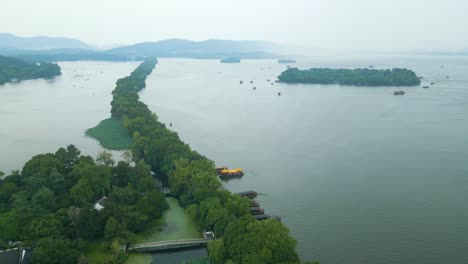 pull back drone view of overcast hangzhou’s west lake, china