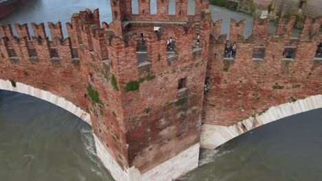 aerial top down rotating shot of castelvecchio bridge - verona italy