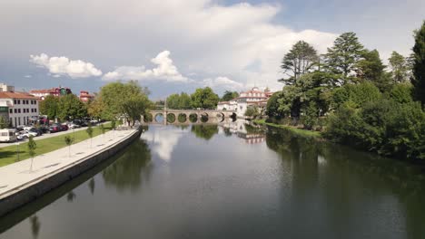 aerial slowly rotating over tamega river panorama at chaves downtown - portugal